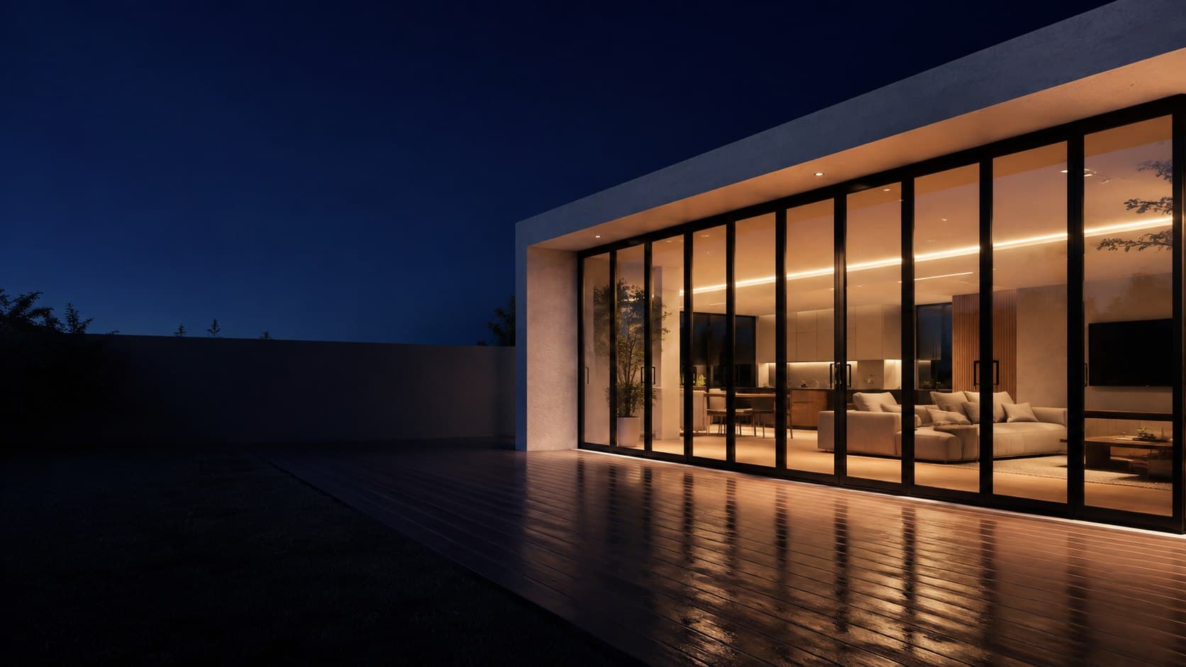 Slim-framed black aluminium stacking doors glowing at dusk on a modern Cape Town home